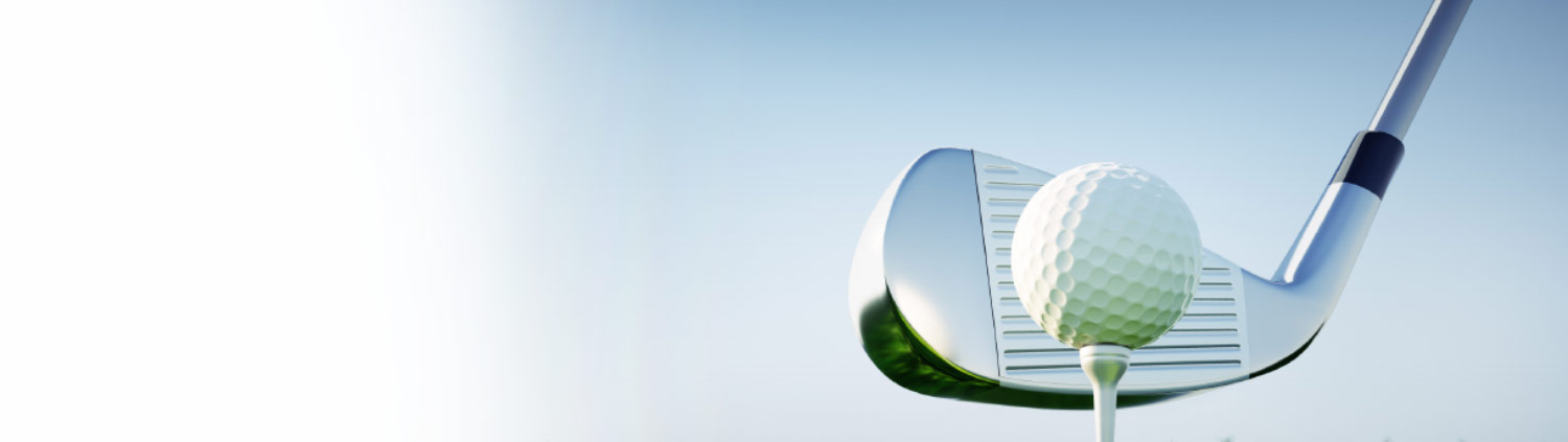 Golf club swinging to hit golf ball.